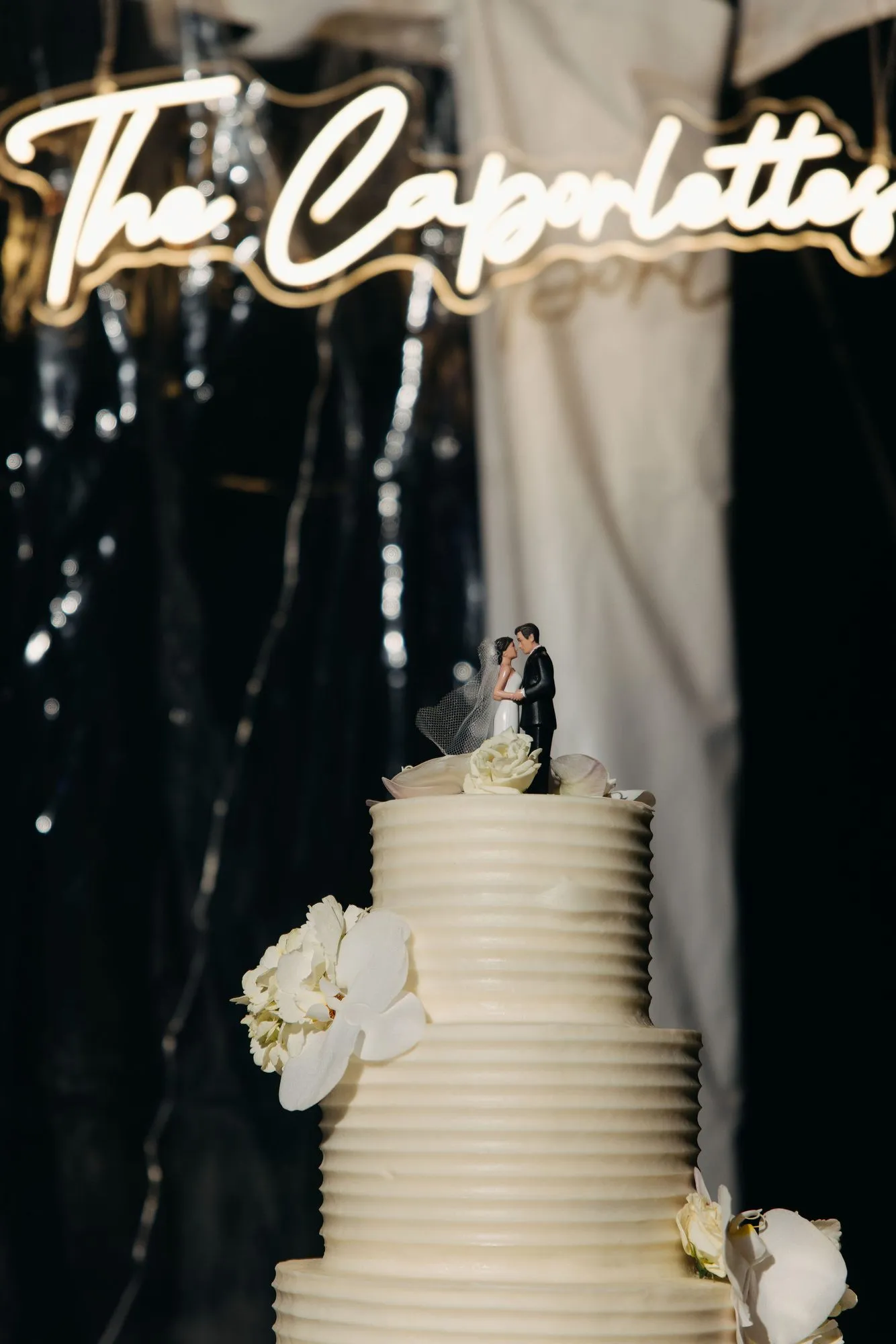 Geode wedding cake lit by a neon sign