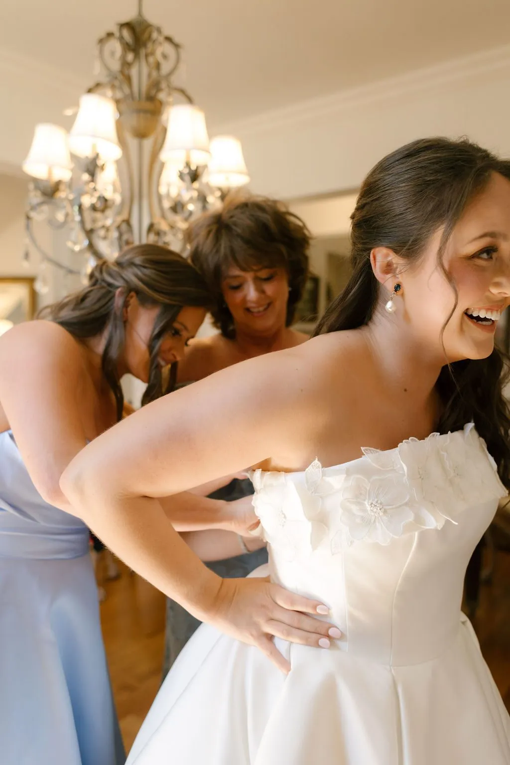 Sally stepping into her dress