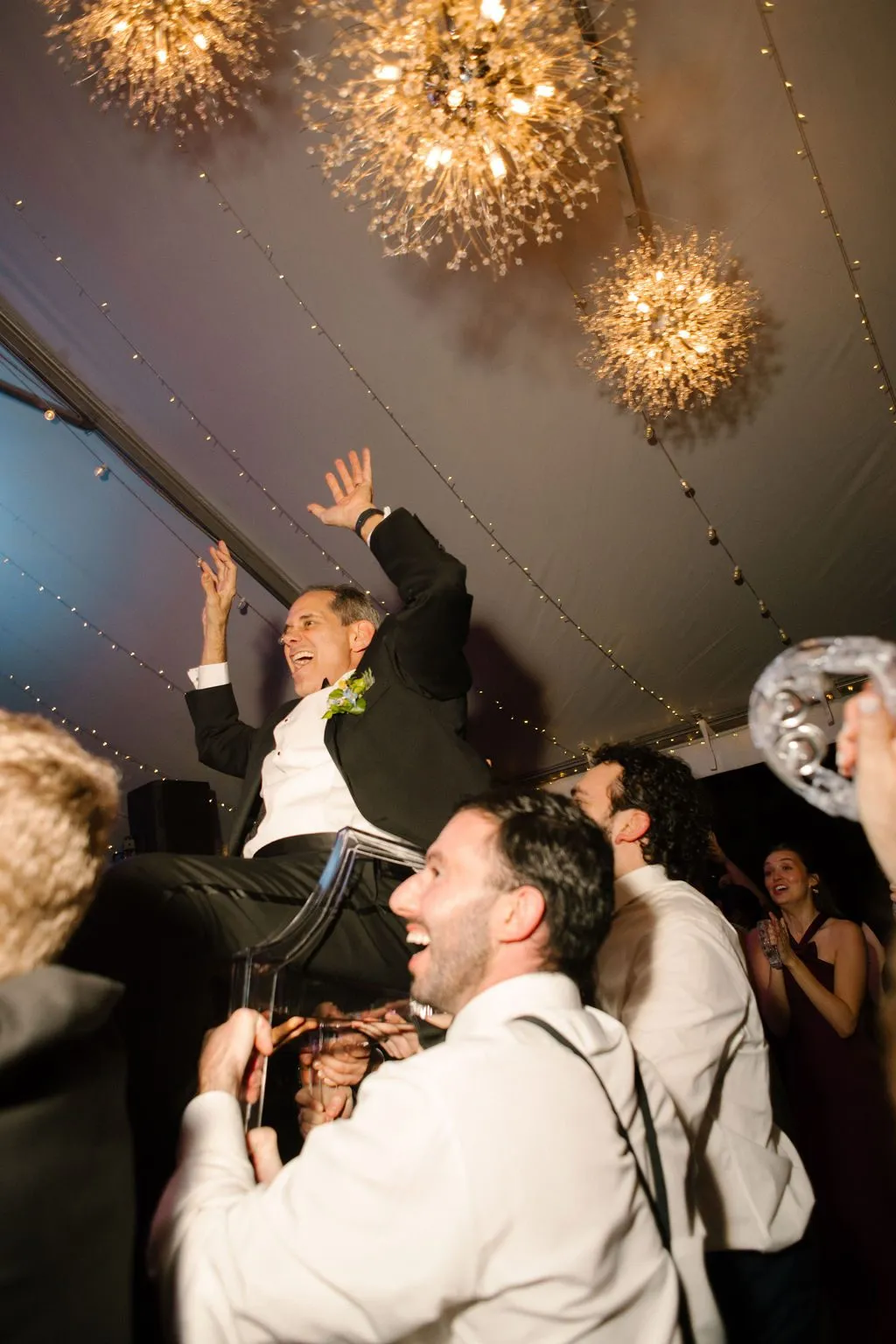 Noah lifted in a chair during the hora