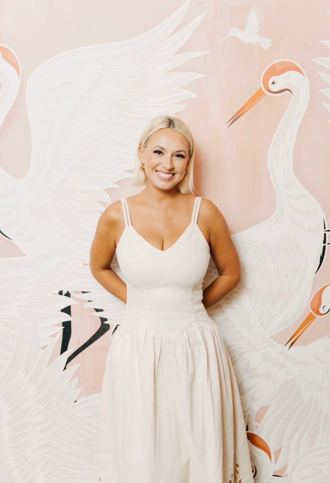 Lyndal Brumley, founder of La Chérie, in front of a hand-painted crane mural
